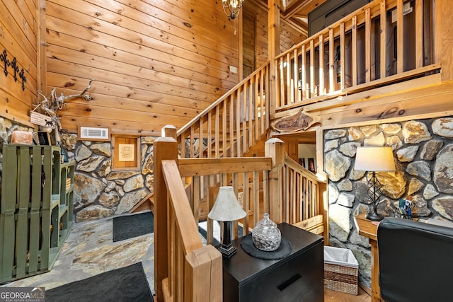 staircase featuring wood walls