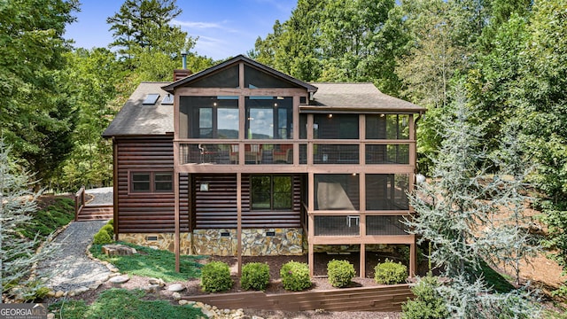 back of property featuring a sunroom