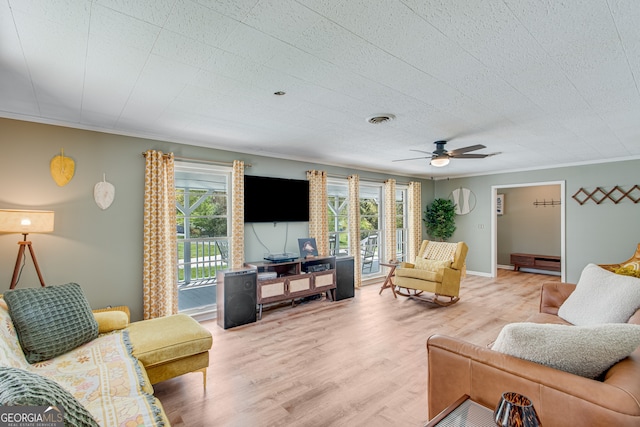 living room with hardwood / wood-style floors, ceiling fan, crown molding, and a baseboard radiator