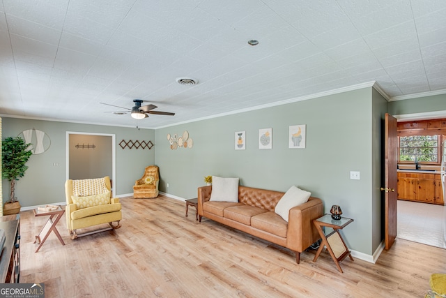 living room with ceiling fan, ornamental molding, and light hardwood / wood-style flooring