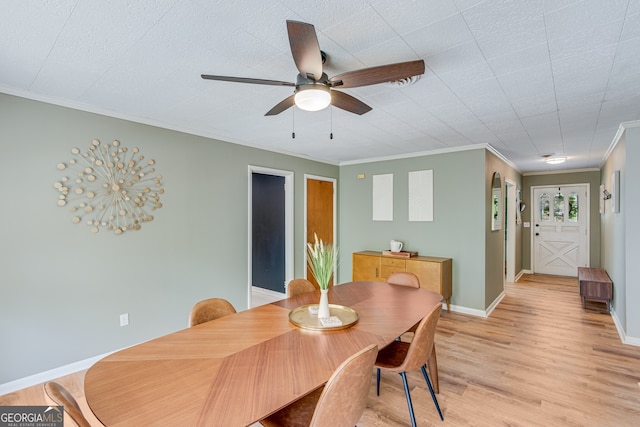 dining room featuring crown molding, light hardwood / wood-style flooring, and ceiling fan