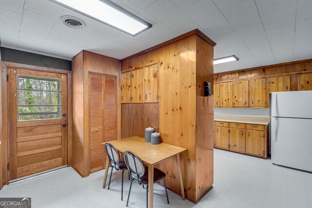 dining area with wooden walls