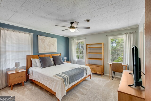 bedroom featuring multiple windows, ceiling fan, light colored carpet, and ornamental molding