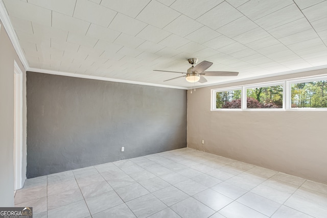 empty room with ceiling fan and ornamental molding