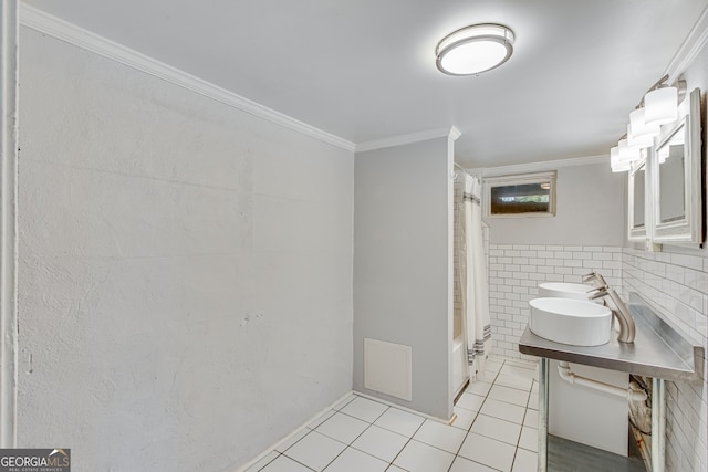 bathroom with tile patterned floors, sink, shower / bathtub combination with curtain, tile walls, and ornamental molding