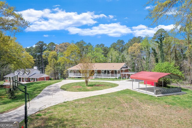 view of front of home featuring a front yard, a carport, and covered porch