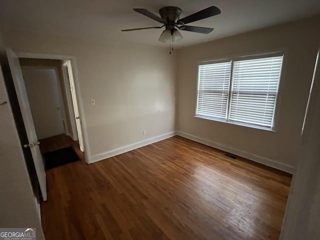 unfurnished bedroom featuring dark hardwood / wood-style floors and ceiling fan