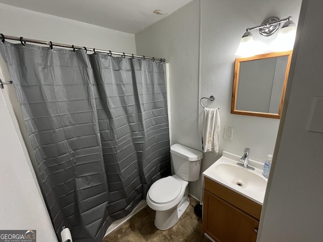 bathroom featuring vanity, toilet, and curtained shower