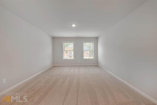 spare room with light colored carpet