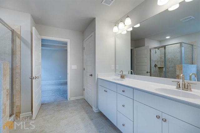 bathroom with vanity, an enclosed shower, and tile patterned floors