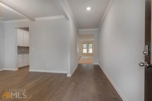 hall with ornamental molding and dark hardwood / wood-style floors