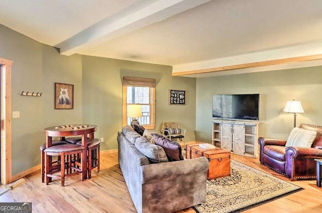 living room featuring beam ceiling and light hardwood / wood-style floors