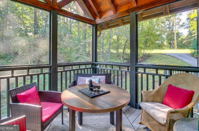 sunroom featuring vaulted ceiling