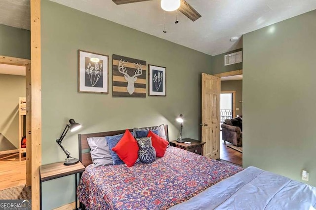 bedroom with hardwood / wood-style floors and ceiling fan