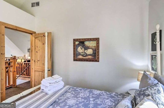 carpeted bedroom featuring high vaulted ceiling