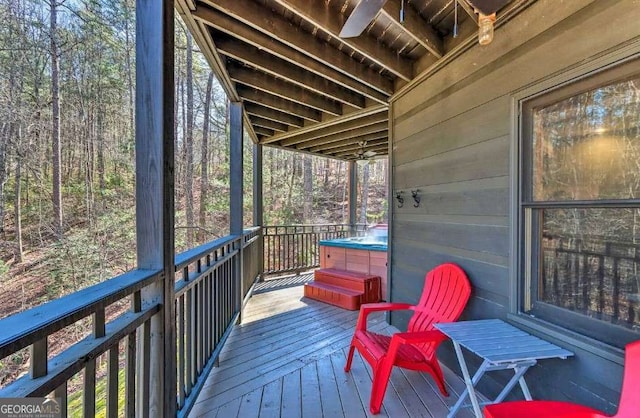 wooden deck with a hot tub