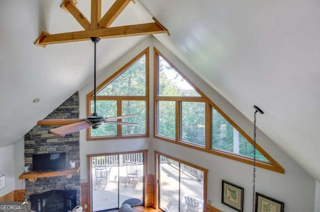 living room featuring a fireplace, high vaulted ceiling, and plenty of natural light