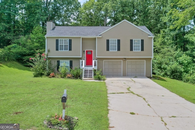 raised ranch with a garage and a front lawn