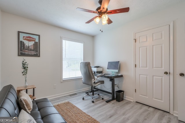 office area featuring ceiling fan, a textured ceiling, and light wood-type flooring