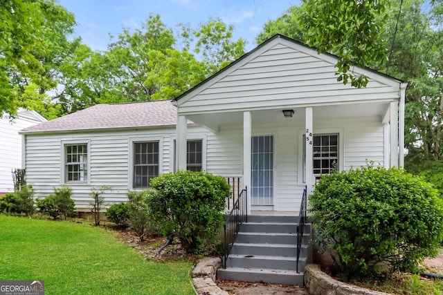 view of front of property featuring a porch and a front lawn