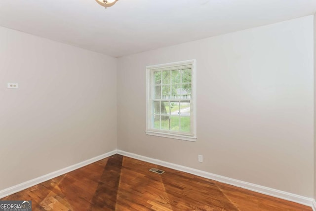 spare room with hardwood / wood-style floors