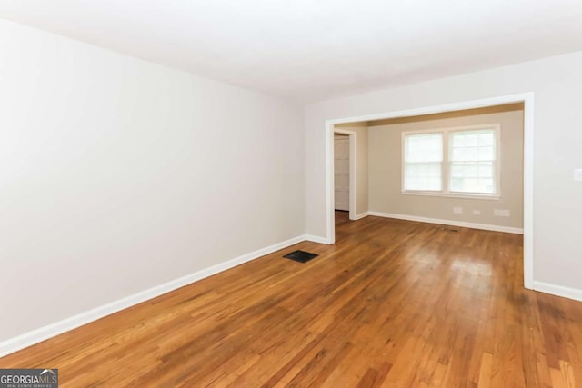 unfurnished room featuring hardwood / wood-style flooring