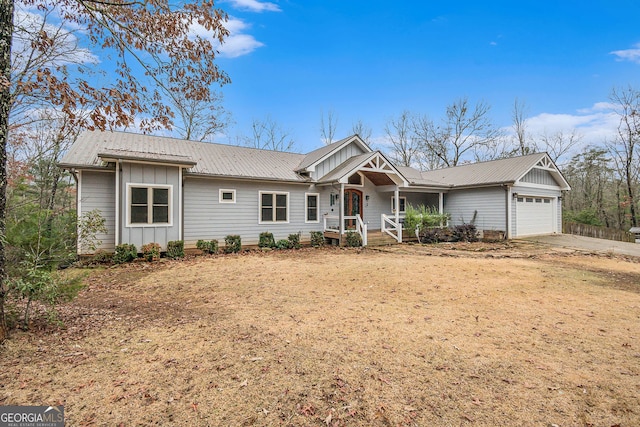 ranch-style house featuring covered porch and a garage