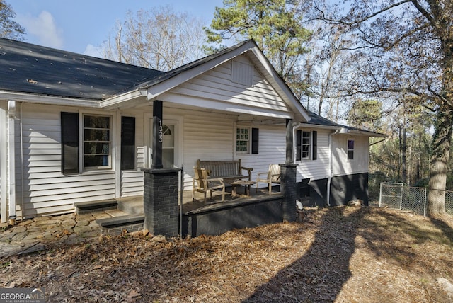 rear view of property with a porch