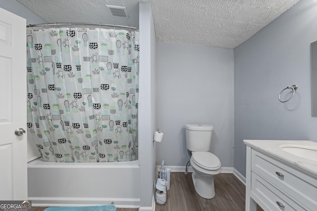 full bathroom featuring a textured ceiling, vanity, wood-type flooring, and shower / bath combo