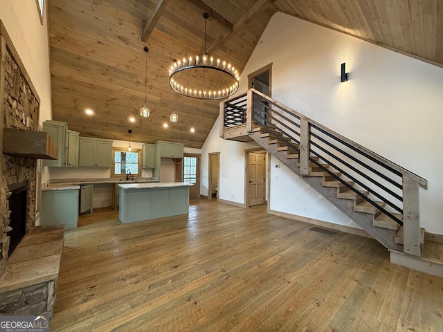 kitchen with hardwood / wood-style floors, high vaulted ceiling, a center island, and wooden ceiling