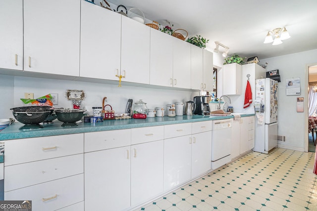 kitchen with white cabinets, white appliances, and sink