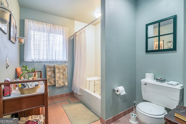 full bathroom featuring toilet, vanity, tile patterned floors, and shower / bath combo with shower curtain