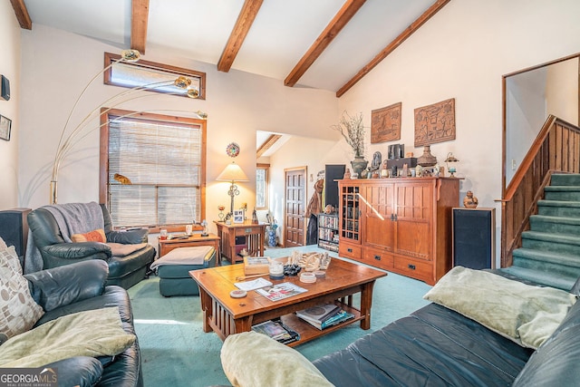 carpeted living room with lofted ceiling with beams