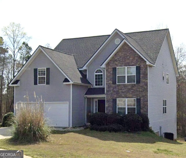 front facade featuring a garage and a front lawn