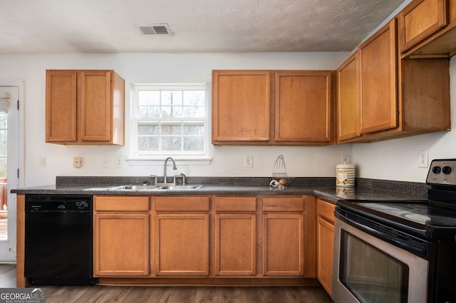 kitchen with visible vents, dark wood finished floors, dishwasher, stainless steel electric range oven, and a sink