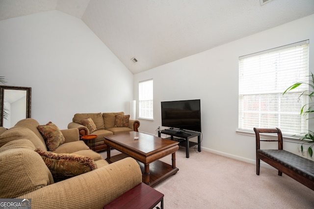 living area featuring high vaulted ceiling, baseboards, visible vents, and light carpet