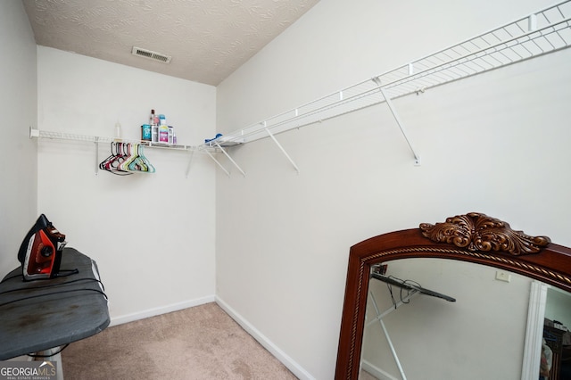 spacious closet with carpet and visible vents