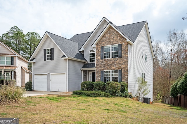 traditional home with a garage, stone siding, a front lawn, and central air condition unit