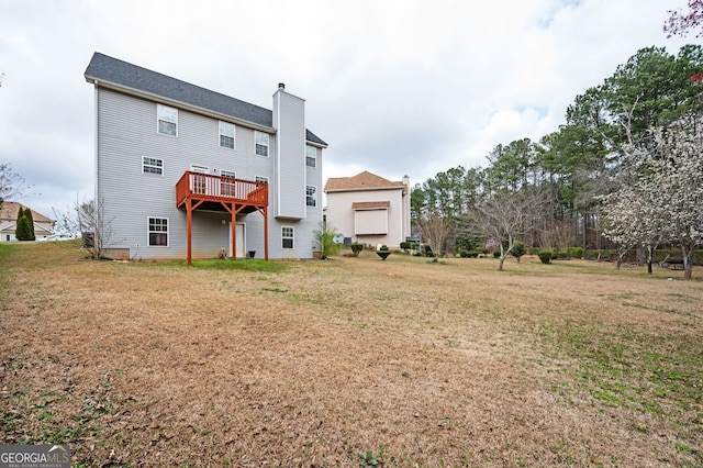 rear view of house with a lawn and a chimney