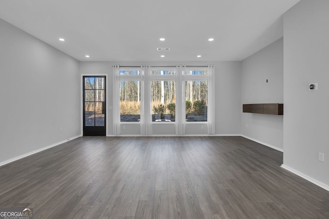 spare room featuring dark wood-type flooring