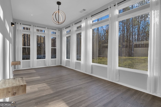 unfurnished sunroom featuring an inviting chandelier