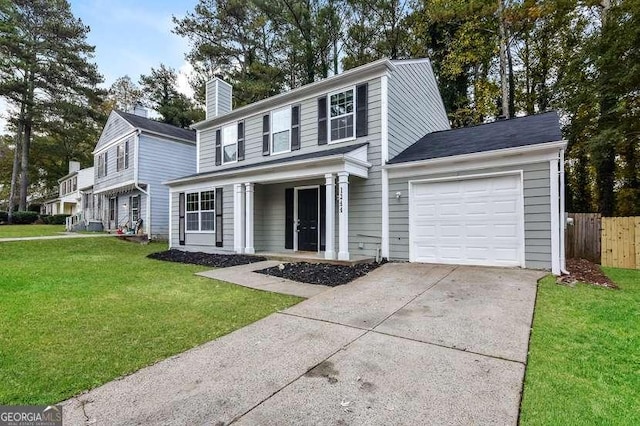 view of front of property with a garage and a front yard