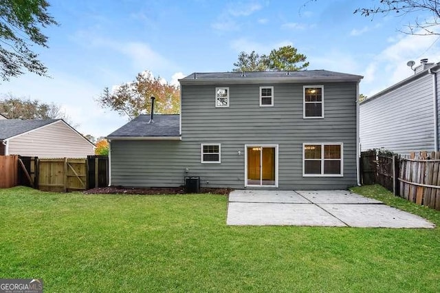 rear view of house with central AC unit, a patio area, and a lawn