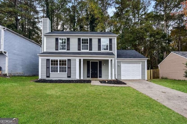 view of front of house featuring a garage and a front lawn