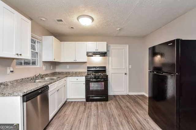 kitchen featuring black appliances, sink, light wood-type flooring, a textured ceiling, and white cabinetry