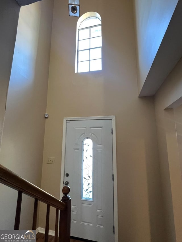 entrance foyer featuring a towering ceiling