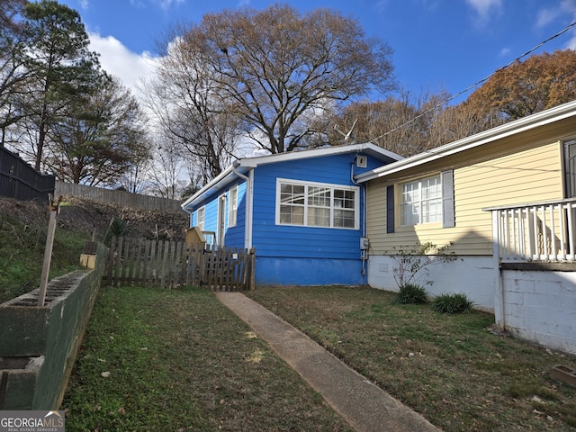 view of side of home with a yard