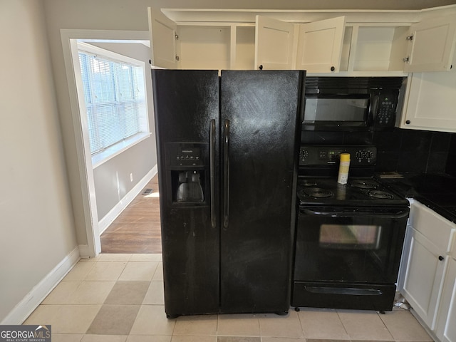 kitchen featuring black appliances, white cabinetry, light tile patterned floors, and tasteful backsplash