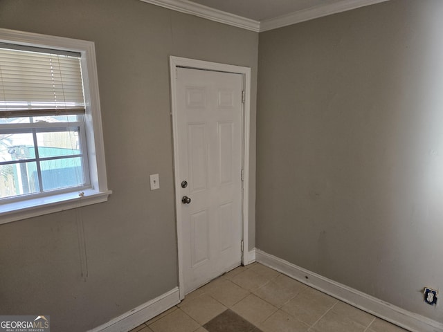 doorway to outside with ornamental molding and light tile patterned flooring