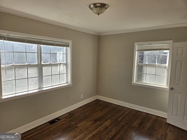 empty room featuring dark hardwood / wood-style flooring and crown molding